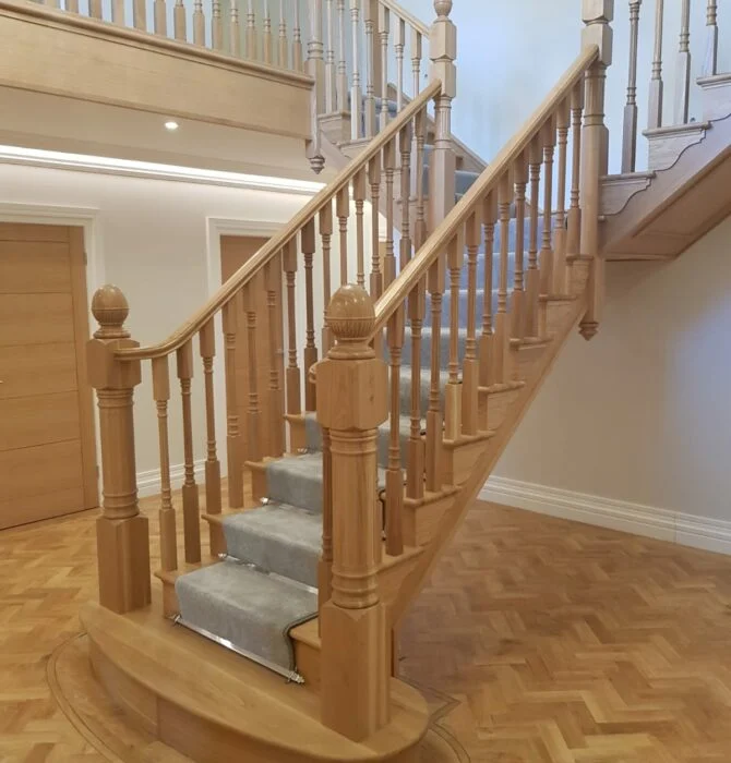 wooden staircase with grey carpet runner